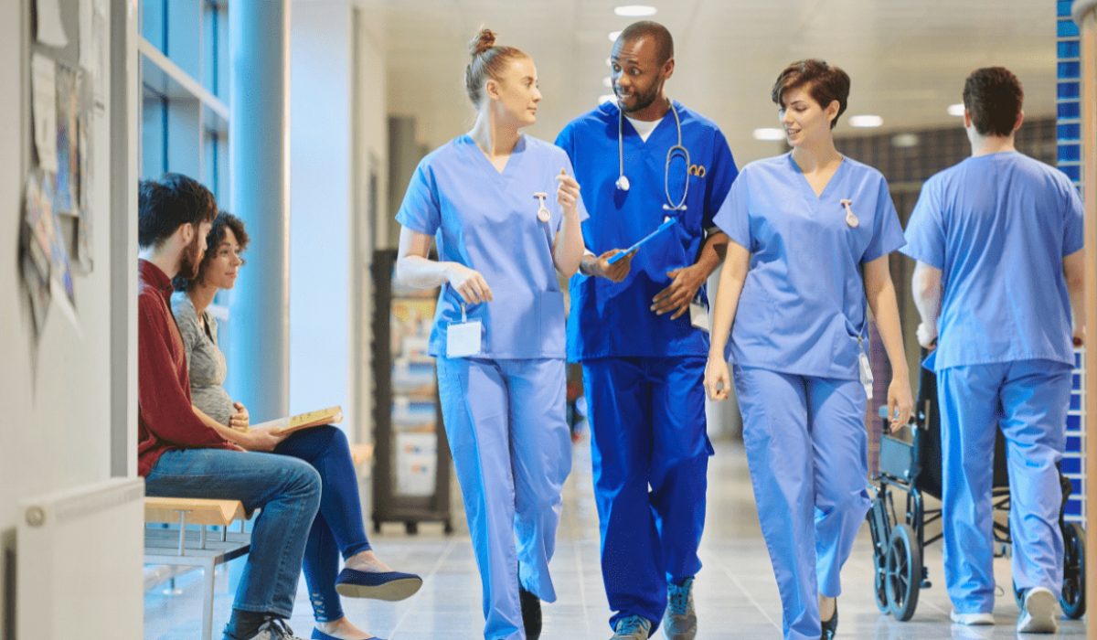 Un equipo médico sanitario camina por el pasillo del hospital.